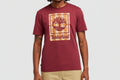 Maroon t-shirt with Timberland logo worn by a person on a white background